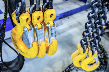 Black steel chain and yellow cargo hooks.