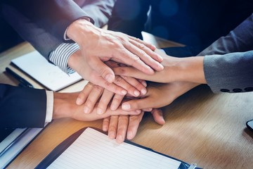 Close-up of businesspeople stacking hands