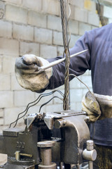 Worker braids end of the steel wire rope slings.