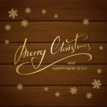 Christmas greetings on brown wooden background