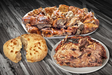 Plateful Of Spit Roasted Pork Slices And Juicy Piglet Ham With Pitta Bread Loaf Isolated On Old Cracked Flaky Wooden Garden Table