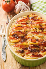 Vegetarian meal - potato casserole with tomatoes, garlic and cheese.