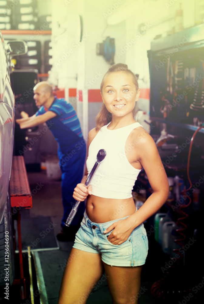 Sticker Smiling woman working in car workshop