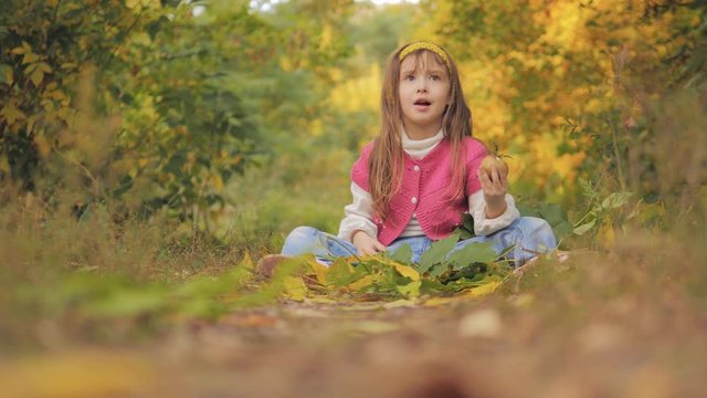 4K Girl Portrait Eating Apple Fruit Autumn Forest View, Child Eats Snack Outdoor
