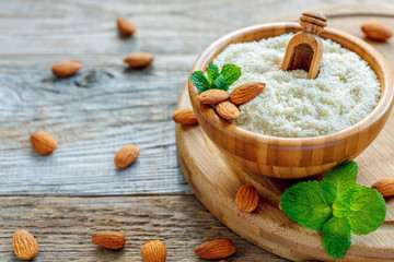 Bowl with almond flour on a wooden stand.