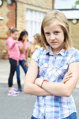 Unhappy Girl Being Gossiped About By School Friends