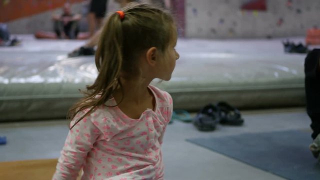 Cute little girl doing gymnastics exercises in sports hall, Children doing sports