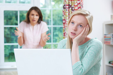 Mother Arguing With Teenage Daughter Over Online Activity