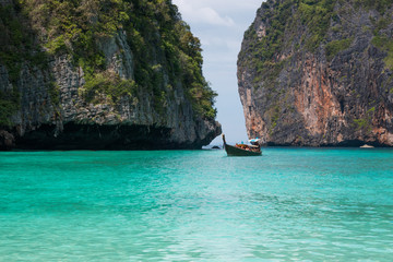 Tropical beach, traditional long tail boats, famous Maya Bay