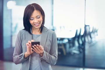 Attractive businesswoman using mobile phone