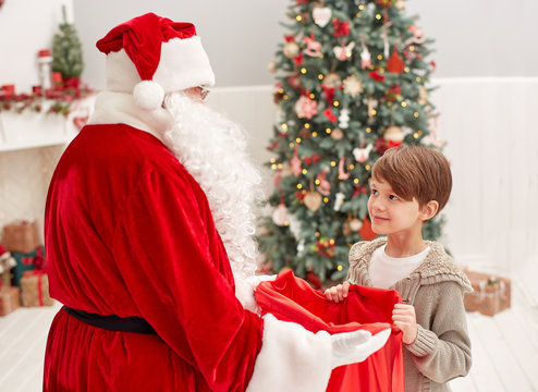 child looks in to the Santa Claus bag