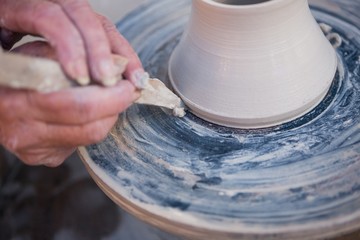 Close-up of potter making pot - Powered by Adobe