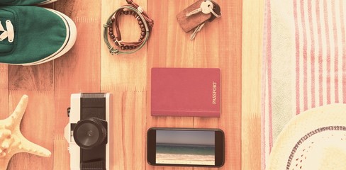 Composite image of accessories and travel items on wooden board