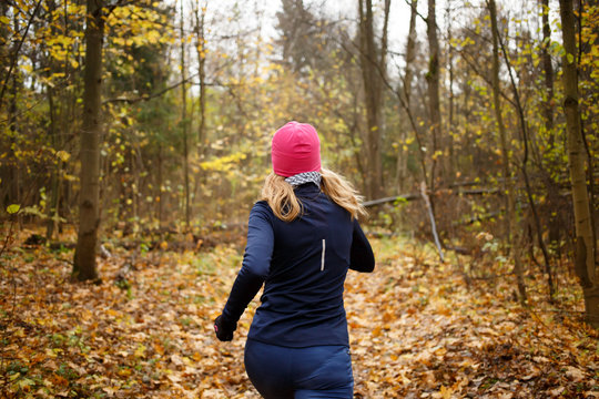 Woman in pink hat jogging