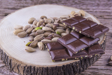 Chocolate and Pistachio nuts on the wood table, wood background