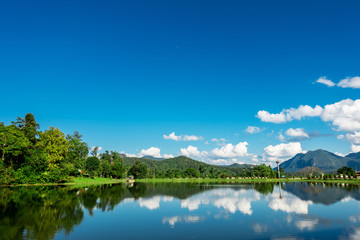 The view at the lake and mountain in the beautiful day with the light blue sky and the nice cloud.