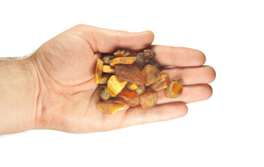 handful of large pieces of amber in palms on white background