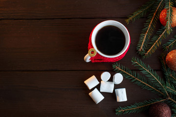Christmas background. Cup of coffee, marshmallow, christmas balls, fir and copyspace for your text