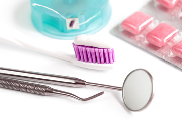 dental care toothbrush with dentist tools on white background
