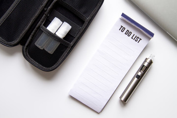 concept of electronic cigarette on white background top view