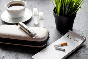 elimination of tobacco smoking electronic cigarette on dark background