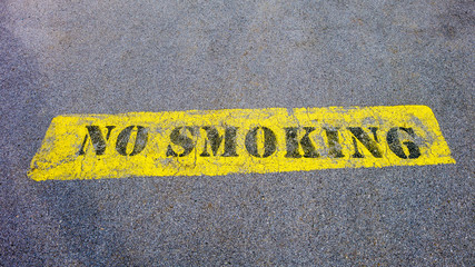 No smoking sign on pavement