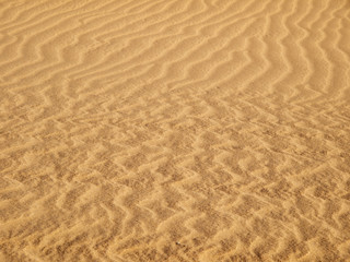 Fototapeta na wymiar Wave sandy texture of dunes in Maspalomas, Gran Canaria