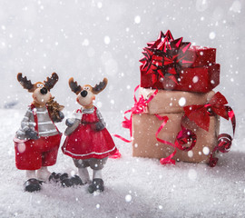 Christmas Gifts in Red and beige Boxes Tied with Festive Ribbons on a White Background in the Snow...