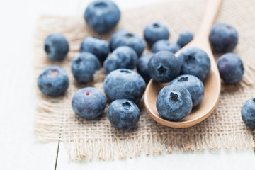 Berries in a wooden spoon on a sack.