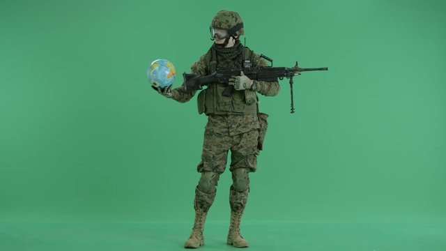 Soldier throwing up globus at green screen