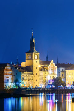 Old Water Tower At Night, Reflection In River. Prague, Czech Republic