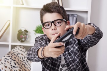child at home playing with the video games or game console