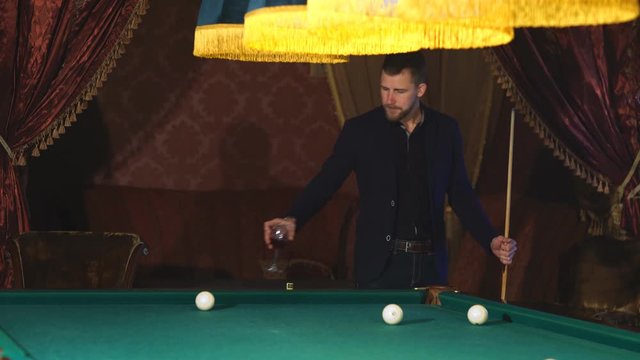 handsome serious man playing pool