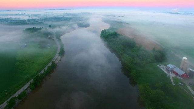 Mystical foggy country landscape with river, farms and homes,aerial view.
