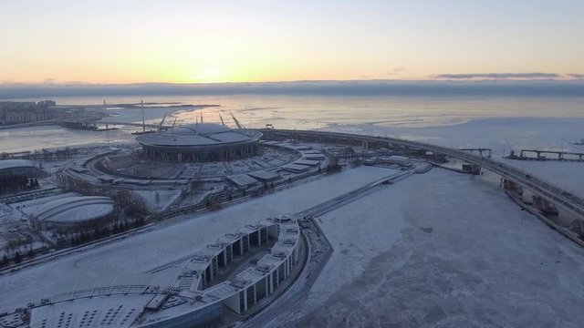 Aerial view of The third cable-stayed bridge, the bridge through a ship waterway, near the football Zenith Arena stadium dated for the FIFA World Cup in 2018, the snow, the frozen river Neva