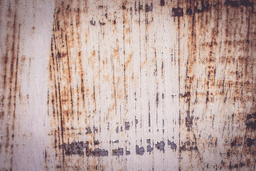 A background of peeling paint and rusty old metal