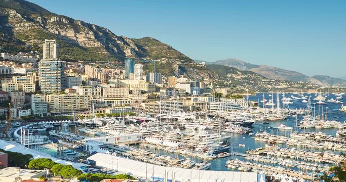 Monaco, Monte-Carlo, 27.09.2016: Timelapse of first day MYS Monaco Yacht Show, Port Hercules, luxury megayachts, big boat, view from Princes Palace of Monaco, sunset, aerial view, 4k video