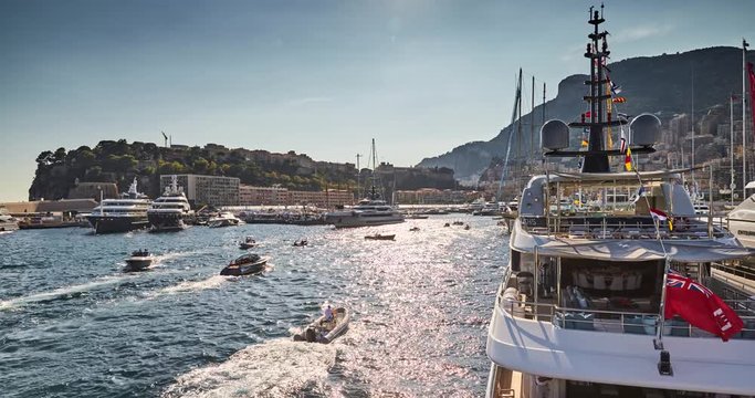Timelapse of World Fair MYS Monaco Yacht Show, Port Hercules, luxury megayachts, big boat, sunny day, many shuttles, taxi boat, presentations, Journalists