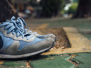 Running shoes on walkway.