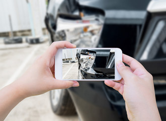 female hold mobile smartphone photographing car accident