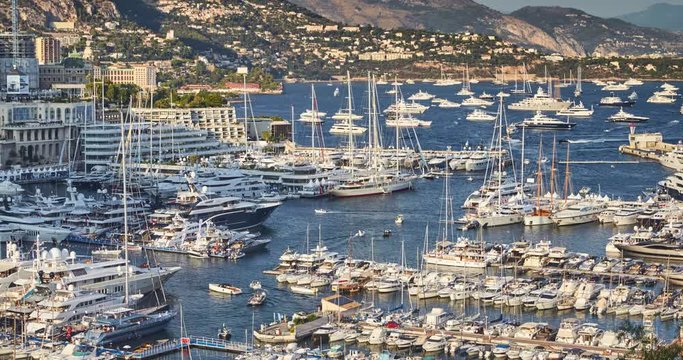 Timelapse of World Fair MYS Monaco Yacht Show, Port Hercules, luxury megayachts, big boat, sunny day, many shuttles, taxi boat, presentations, Journalists