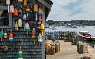 New England Lobster Fishing Dock:  Marker buoys for lobster traps decorate the side of a fishing...