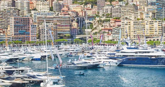 World Fair MYS Monaco Yacht Show, Port Hercules, luxury megayachts, many shuttles, taxi boat, presentations, Journalists, boat traffic, Azur water, aerial view, mountains on background, perspective