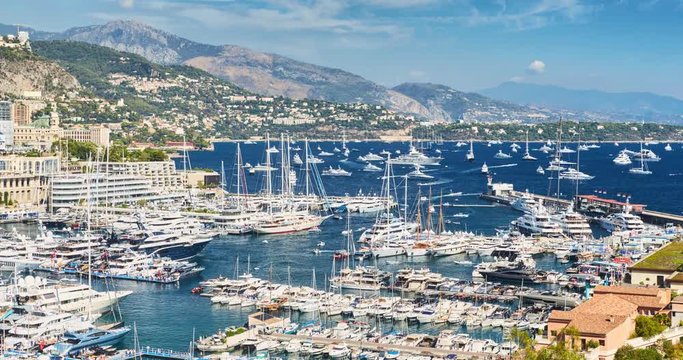 Timelapse of World Fair MYS Monaco Yacht Show, Port Hercules, luxury megayachts, big boat, sunny day, many shuttles, taxi boat, presentations, Journalists, zoom effect, boat traffic, Azur water,