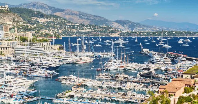 Timelapse of World Fair MYS Monaco Yacht Show, Port Hercules, luxury megayachts, big boat, sunny day, many shuttles, taxi boat, presentations, Journalists, zoom effect, boat traffic, Azur water,