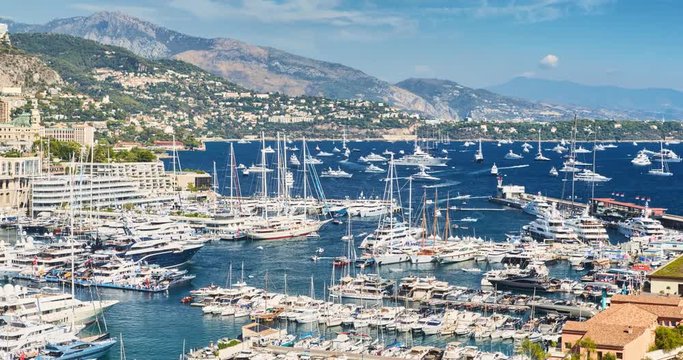 Timelapse of World Fair MYS Monaco Yacht Show, Port Hercules, luxury megayachts, big boat, sunny day, many shuttles, taxi boat, presentations, Journalists, zoom effect, boat traffic, Azur water,