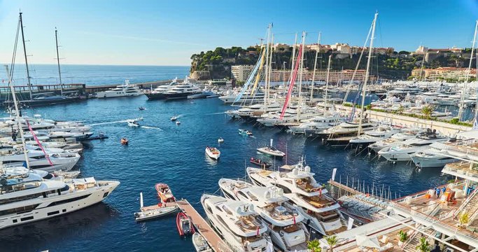 Monaco, Monte-Carlo, 29 September 2016: Timelapse of World Fair MYS Monaco Yacht Show, Port Hercules, luxury megayachts, many shuttles, taxi boat, presentations, Journalists, boat traffic, Azur water