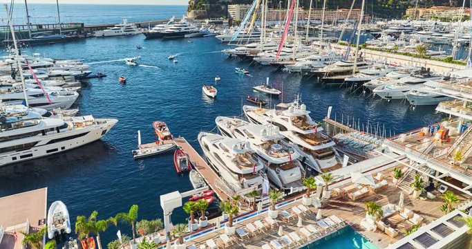 Monaco, Monte-Carlo, 29 September 2016: Timelapse of World Fair MYS Monaco Yacht Show, Port Hercules, luxury megayachts, many shuttles, taxi boat, presentations, Journalists, boat traffic, Azur water