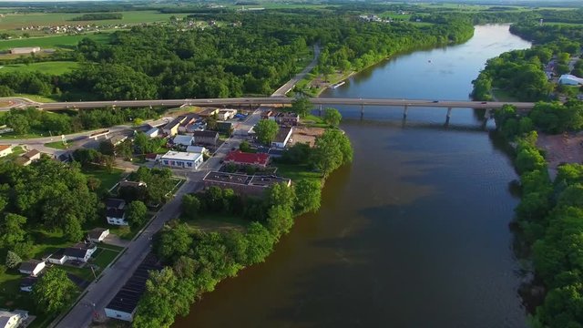 Jet-skiing on river,under bridge, summer evening in small town America, aerial view.
