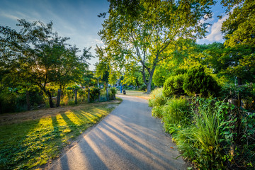 Fototapeta na wymiar Walkway and gardens at sunset, at Back Bay Fens, in Boston, Mass